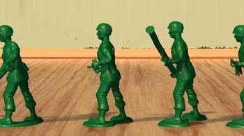 Movie still from “Toy Story” (1995), directed by John Lasseter – Two green toy soldiers are standing in a room; Medium shot, Low angle