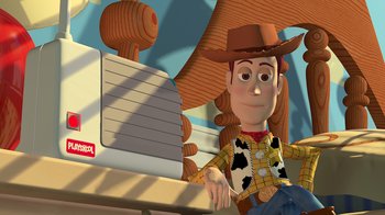 Movie still from “Toy Story” (1995), directed by John Lasseter – A toy story character sitting in front of a computer screen; Medium shot, Low angle