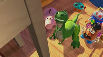 Movie still from “Toy Story” (1995), directed by John Lasseter – A green dinosaur and a pink pig in a room with wood floors; Wide shot, High angle