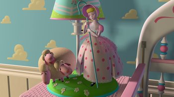 Movie still from “Toy Story” (1995), directed by John Lasseter – A lamp with a sheep on it next to a lady doll; Wide shot, High angle