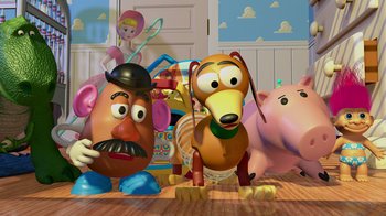 Movie still from “Toy Story” (1995), directed by John Lasseter – Toy story characters are sitting on the floor; Wide shot, Low angle