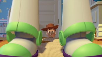Movie still from “Toy Story” (1995), directed by John Lasseter – The toy story character is looking at the camera; Wide shot, Low angle