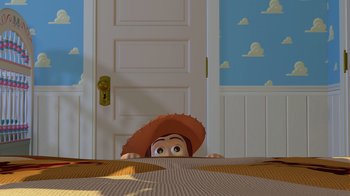 Movie still from “Toy Story” (1995), directed by John Lasseter – A toy story character peeks out from behind a door; Wide shot, Overhead angle