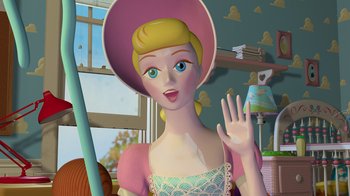 Movie still from “Toy Story” (1995), directed by John Lasseter – A cartoon of a woman in a pink hat waving; Close Up shot, Low angle