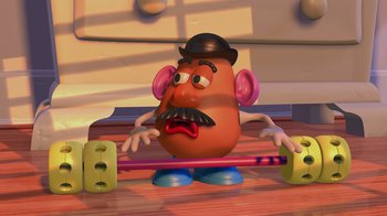 Movie still from “Toy Story” (1995), directed by John Lasseter – A toy potato sitting on top of a wooden floor; Medium shot, Low angle