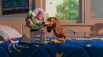 Movie still from “Toy Story” (1995), directed by John Lasseter – A dog and a toy story character on a bed; Wide shot, Overhead angle