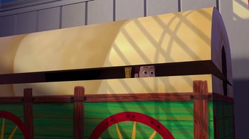Movie still from “Toy Story” (1995), directed by John Lasseter – A person's face peeking out from behind a fence; Extreme Wide shot, Low angle