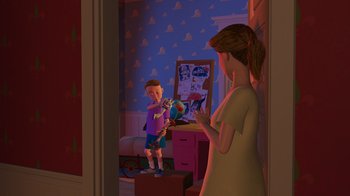 Movie still from “Toy Story” (1995), directed by John Lasseter – A woman and a child in a room with toy story posters on the wall; Medium shot, Over the shoulder angle