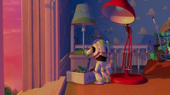 Movie still from “Toy Story” (1995), directed by John Lasseter – A toy is sitting on a table next to a lamp; Extreme Wide shot, High angle
