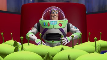 Movie still from “Toy Story” (1995), directed by John Lasseter – Buzz lightyear sitting in front of a bunch of green apples; Medium shot, Overhead angle