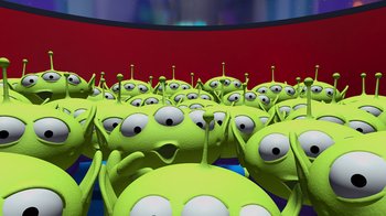 Movie still from “Toy Story” (1995), directed by John Lasseter – A bunch of green aliens are in a room; Extreme Wide shot, High angle
