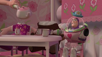 Movie still from “Toy Story” (1995), directed by John Lasseter – A toy story character sitting at a table with a coffee cup; Wide shot, Over the shoulder angle