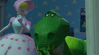 Movie still from “Toy Story” (1995), directed by John Lasseter – A green toy dinosaur next to a pink doll; Close Up shot, Low angle