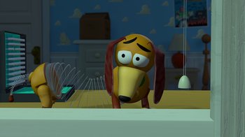 Movie still from “Toy Story” (1995), directed by John Lasseter – A toy dog is sitting on a table; Medium shot, High angle