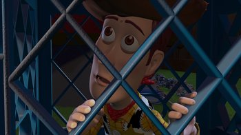 Movie still from “Toy Story” (1995), directed by John Lasseter – A man in a cowboy outfit behind a fence; Close Up shot, High angle