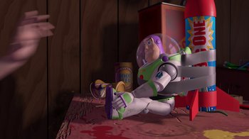 Movie still from “Toy Story” (1995), directed by John Lasseter – Buzz lightyear sitting on the ground in a room; Wide shot, Overhead angle
