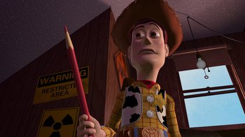 Movie still from “Toy Story” (1995), directed by John Lasseter – A person holding a red pencil in his hand; Medium shot, Over the shoulder angle