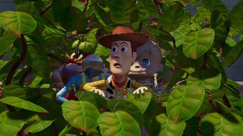 Movie still from “Toy Story” (1995), directed by John Lasseter – A group of people standing in the leaves of a tree; Extreme Wide shot, High angle