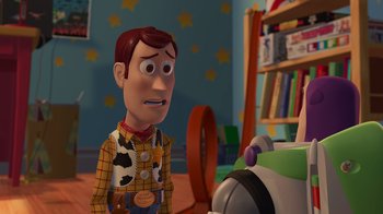 Movie still from “Toy Story 2” (1999), directed by Lee Unkrich – A man in a toy story outfit standing in front of a robot; Medium shot, Over the shoulder angle