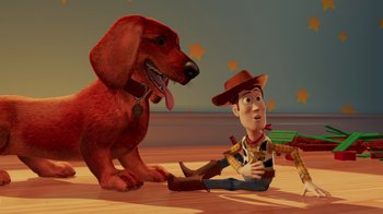 Movie still from “Toy Story 2” (1999), directed by Lee Unkrich – A dog and a man sitting on the floor; Wide shot, Over the shoulder angle