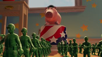 Movie still from “Toy Story 2” (1999), directed by Lee Unkrich – A group of green toy soldiers surrounding a large pig statue; Wide shot, Low angle