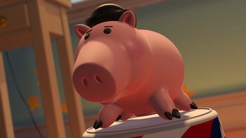 Movie still from “Toy Story 2” (1999), directed by Lee Unkrich – A toy pig wearing a hat sitting on top of a table; Extreme Close Up shot, Low angle