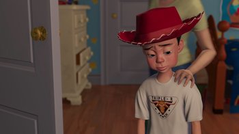Movie still from “Toy Story 2” (1999), directed by Lee Unkrich – A young boy wearing a red cowboy hat in a room; Medium shot, Over the shoulder angle