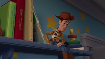 Movie still from “Toy Story 2” (1999), directed by Lee Unkrich – A toy story character sitting on top of a book shelf; Medium shot, Low angle