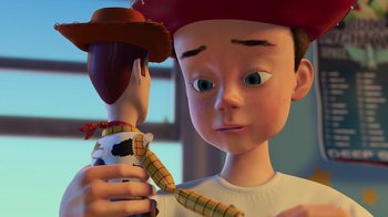 Movie still from “Toy Story 2” (1999), directed by Lee Unkrich – A young boy holding a toy story figure; Close Up shot, Over the shoulder angle