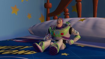 Movie still from “Toy Story 2” (1999), directed by Lee Unkrich – A toy story character sitting on a bed; Wide shot, High angle