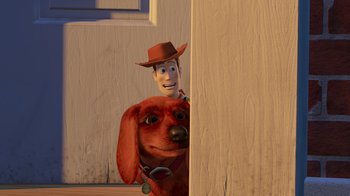 Movie still from “Toy Story 2” (1999), directed by Lee Unkrich – A red dog with a cowboy hat on and a man in a red hat; Close Up shot, Over the shoulder angle