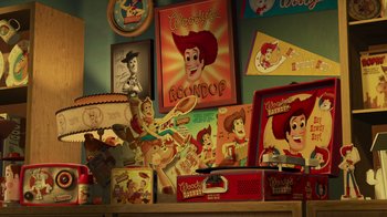 Movie still from “Toy Story 2” (1999), directed by Lee Unkrich – A collection of toy story memorabilia on a shelf; Extreme Wide shot, High angle