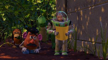 Movie still from “Toy Story 2” (1999), directed by Lee Unkrich – A group of toy story characters standing next to each other on the ground; Wide shot, Over the shoulder angle