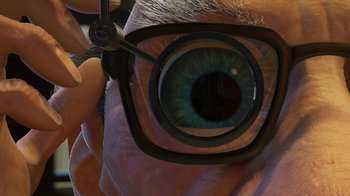 Movie still from “Toy Story 2” (1999), directed by Lee Unkrich – A person with a pair of glasses looking through a pair of scissors; Extreme Close Up shot, Low angle