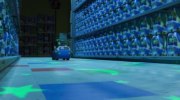 Movie still from “Toy Story 2” (1999), directed by Lee Unkrich – A toy car in front of a wall full of bottles; Extreme Wide shot, High angle