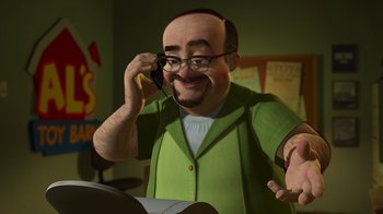 Movie still from “Toy Story 2” (1999), directed by Lee Unkrich – An animated man talking on a cell phone while holding a book; Medium shot, High angle