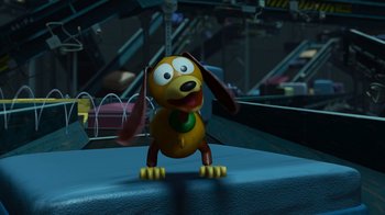 Movie still from “Toy Story 2” (1999), directed by Lee Unkrich – A toy dog is sitting on the ground; Wide shot, High angle