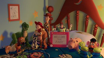 Movie still from “Toy Story 2” (1999), directed by Lee Unkrich – Toy story characters are sitting on a bed; Extreme Wide shot, High angle