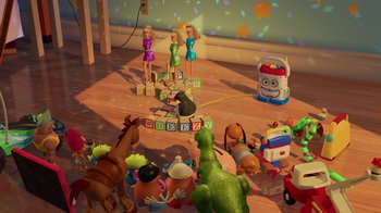 Movie still from “Toy Story 2” (1999), directed by Lee Unkrich – A group of people in a room with toys on the floor; Wide shot, High angle