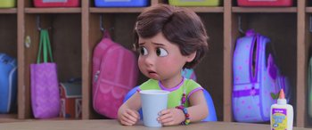 Movie still from “Toy Story 4” (2019), directed by Josh Cooley – A little girl sitting at a table holding a cup; Close Up shot, Over the shoulder angle
