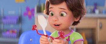 Movie still from “Toy Story 4” (2019), directed by Josh Cooley – A little girl is holding a fork in her hands; Close Up shot, Over the shoulder angle
