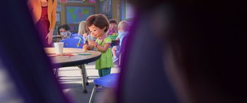 Movie still from “Toy Story 4” (2019), directed by Josh Cooley – A little girl holding a cell phone at a table; Medium shot, Over the shoulder angle