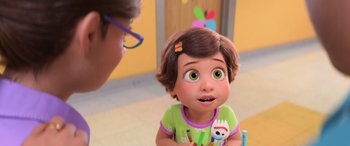 Movie still from “Toy Story 4” (2019), directed by Josh Cooley – A person with glasses and a green shirt is talking to a child; Close Up shot, Over the shoulder angle
