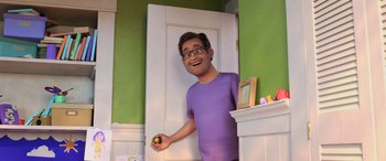Movie still from “Toy Story 4” (2019), directed by Josh Cooley – An animated man holding an apple in front of a white door; Medium shot, High angle