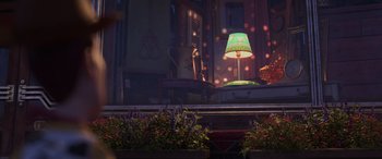 Movie still from “Toy Story 4” (2019), directed by Josh Cooley – A green lamp sitting on top of a table next to flowers; Extreme Wide shot, High angle