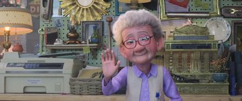 Movie still from “Toy Story 4” (2019), directed by Josh Cooley – An old man with glasses waving at the camera; Wide shot, Over the shoulder angle