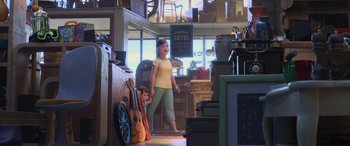 Movie still from “Toy Story 4” (2019), directed by Josh Cooley – A woman standing next to a bunch of guitars; Wide shot, Over the shoulder angle