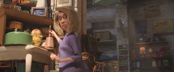 Movie still from “Toy Story 4” (2019), directed by Josh Cooley – A woman in a purple dress is standing in a room; Medium shot, Over the shoulder angle