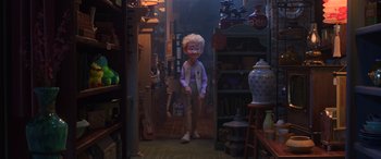 Movie still from “Toy Story 4” (2019), directed by Josh Cooley – A person standing in a room with many items; Wide shot, High angle