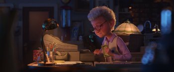 Movie still from “Toy Story 4” (2019), directed by Josh Cooley – An old woman is sitting at a desk with papers; Medium shot, Over the shoulder angle